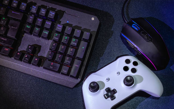 istock Top view of the gaming console, keyboard, and mouse on a table 1440549573