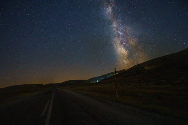 istock Dark night sky with many stars above a field 1440549712