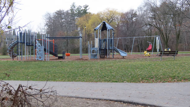 istock Empty playground in a park on background of trees 1440549921