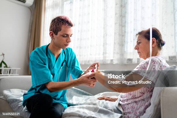 Health Visitor And A Woman During Home Stock Photo - Download Image Now - Healthcare And Medicine, Transgender Person, LGBTQIA People