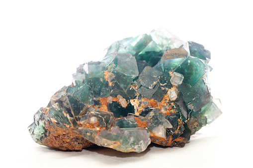 Cluster of several transparent quartz crystals close-up on a white background