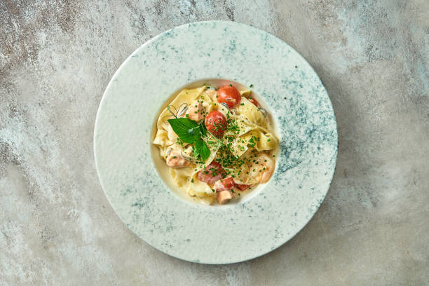 istock Pasta with salmon and vegetables in a plate. Selective focus, close-up 1440550491