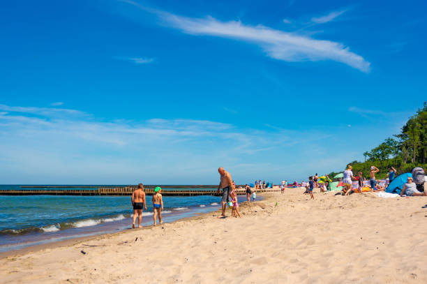 Sopot, Poland - 11.05.2022: People walk along the autumn sea embankment