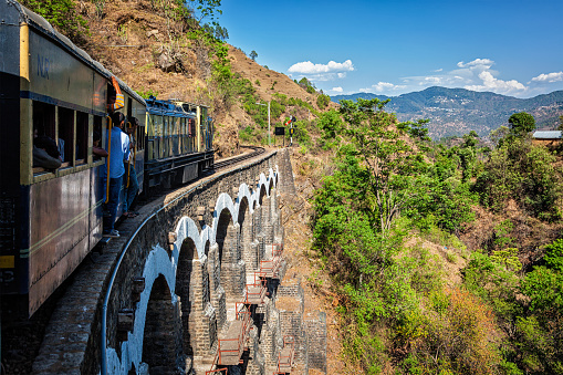 Himachal Pradesh, India - May 12, 2010: Toy train of Kalka - Shimla Railway - narrow gauge railway built in 1898 and famous for its scenery and improbable construction. It is UNESCO World Heritage Site