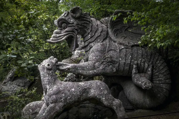 Photo of Large statue of the Dragon bitten by a lion and a wolf at the famous Gardens of Bomarzo, Viterbo