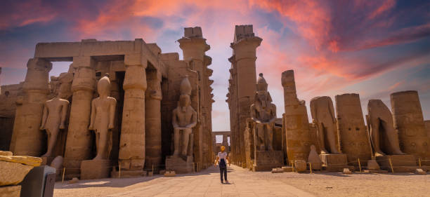 Sculptures of ancient Egyptian pharaohs Sculptures of ancient Egyptian pharaohs and drawings on the columns of the Luxor Temple in the evening. Egypt ramses i stock pictures, royalty-free photos & images