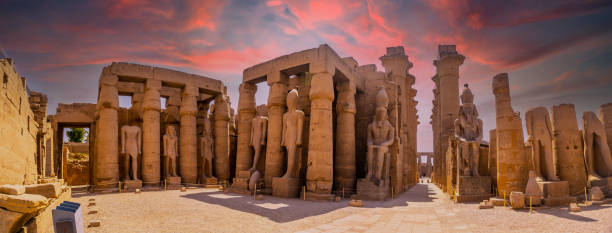Sculptures of ancient Egyptian pharaohs Sculptures of ancient Egyptian pharaohs and drawings on the columns of the Luxor Temple in the evening. Egypt ramses i stock pictures, royalty-free photos & images