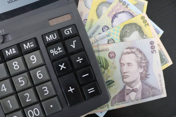 istock Calculator and Romanian leu banknotes on a black background 1440552352