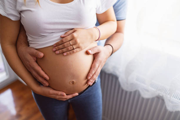 istock Unrecognizable couple with hands on the pregnant belly 1440552469