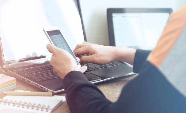 istock Close up of male hands with mobile phone. Man is using internet for work from home 1440552664