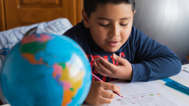 istock High angle shot of a Hispanic child studying at home 1440552704