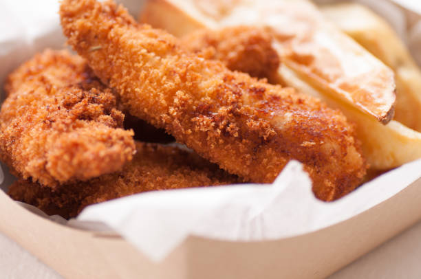 istock chicken strips and fries in a take out container 1440553850