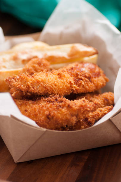 istock chicken strips and fries in a take out container 1440553935