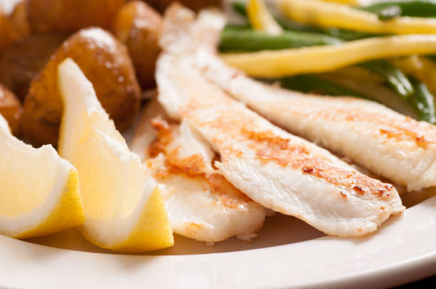 istock healthy white fish fillets with vegetables 1440554060