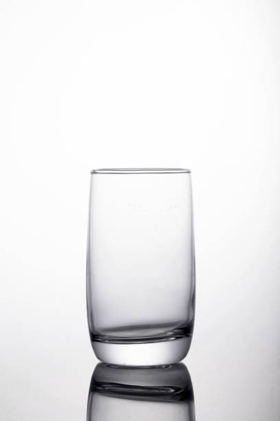 istock Vertical shot of glass for water on a reflecting surface 1440554550