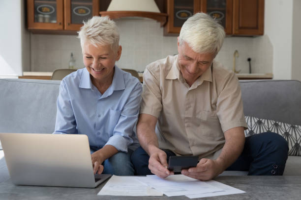 istock Older spouses managing finances, using laptop, paying bills through e-bank 1440555136