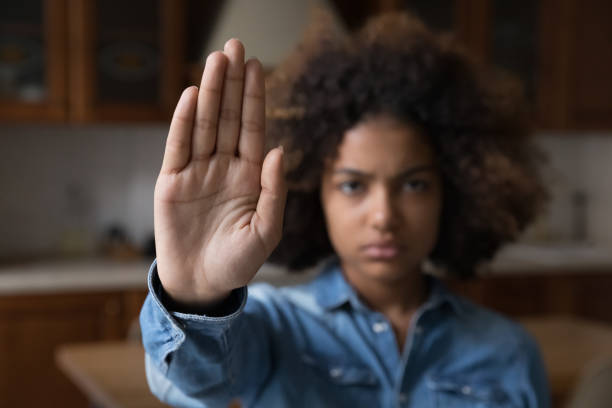 istock Serious African girl raise her palm makes stop gesture 1440555199