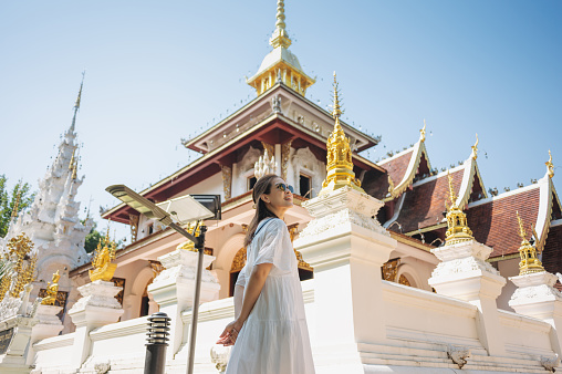 Wonderlust lifestyle Young mid age asian hapiness fun solo travel woman exploring Wat Pa Dara Phirom Phra Aram Luang temple famaus toursit attraction in Chiang Mai north of thailand