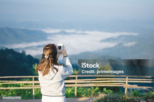 istock Modern generation women using instant camera and film taking photo the sunrise at nature scenics landscape on monjam chiang mai thailand 1440555995