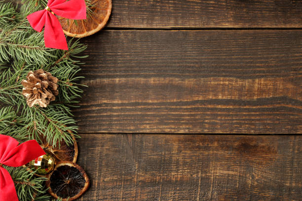 istock New Year and Christmas frame for text with a Christmas tree and colored Christmas decorations on a brown background. view from above. 1440556875