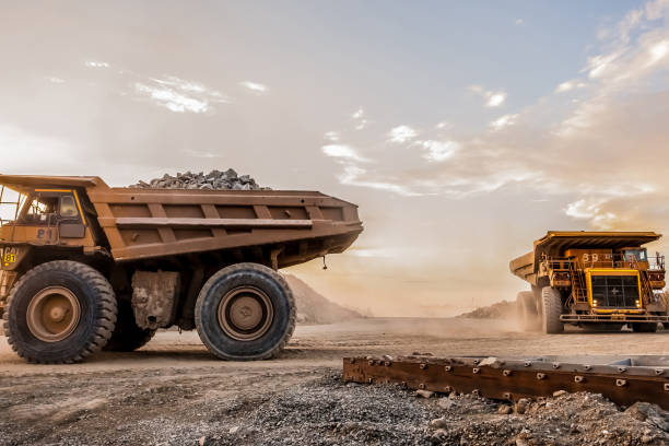 istock Trucks loaded with crushed rock fragments for transporting in platinum mining open pit, South Africa 1440557166