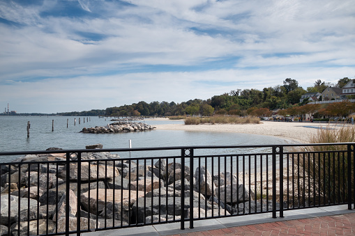 The railing along the York River in Yorktown, VA with the view of Yorktown Beach