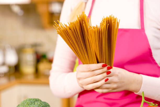 istock Woman holding long pasta 1440557786