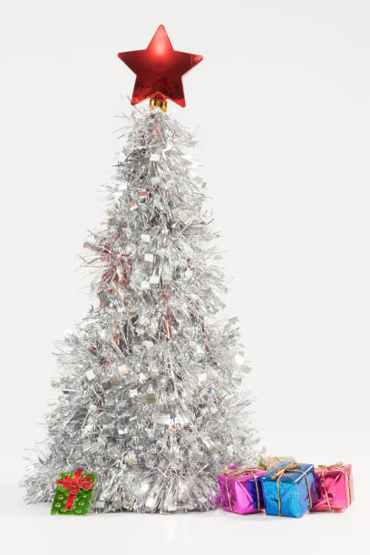 istock Festive composition with a silver Christmas tree and colorful gift boxes 1440559200