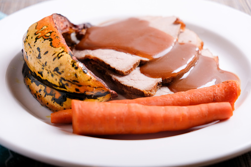 roast pork dinner with squash and gravy