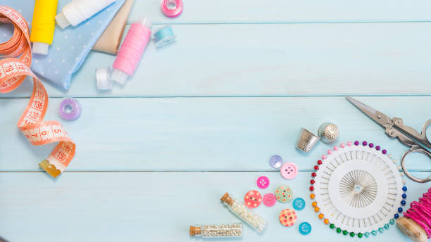 istock Sewing accessories on a light blue wooden background 1440560078