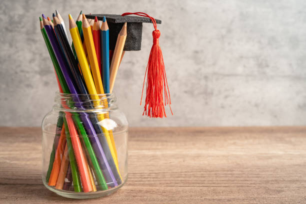 istock Graduation hat with colorful pencils on book with copy space, learning university education concept. 1440561755