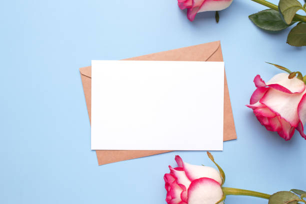 istock Mockup invitation, blank greeting card and rose flowers. Flat lay, top view. 1440561785