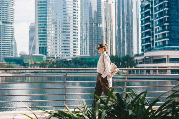 istock Woman walking with modern city background 1440566219