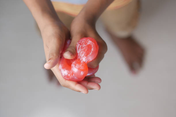istock child Hand holding pink color slime 1440567809