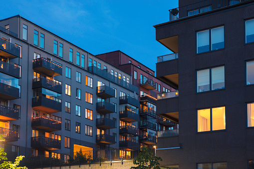 A street with modern apartment buildings at night in Hammarby Sjöstad, Stockholm, Sweden.