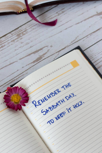 istock Remember Sabbath Day to keep it holy, handwritten text in a notebook with Holy Bible Book on wooden background, vertical shot 1440570005