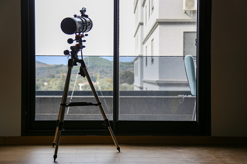 Telescope near window in day time