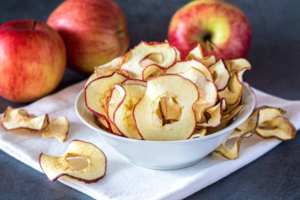 istock Dried organic apple slice chips in bowl 1440570980
