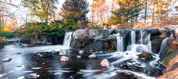 Long exposure shot of man-made waterfalls in a south Chicago, IL suburb taken during the autumn season.