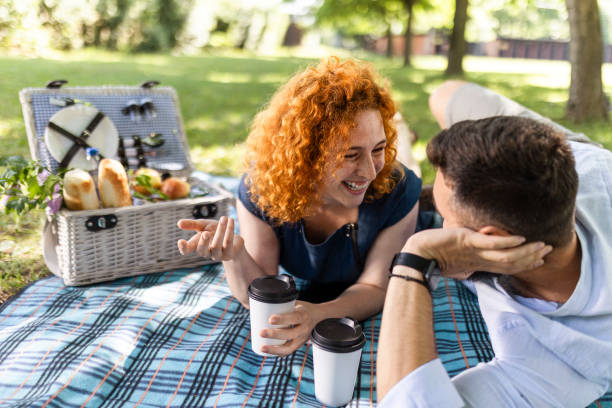 istock Young smiling couple having a picnic 1440572837