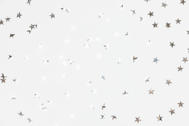 istock Silver sparkle confetti stars isolated on white background. Glitter, shine, bright. Christmas festive flat lay, winter holiday, new year, happy birthday concept. Flat lay, top view, copy space. 1440574061