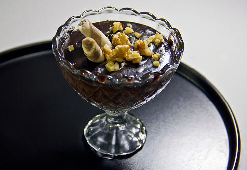 chocolate pudding with banana and grapes in a cup