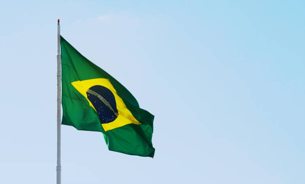 istock Brazilian flag waving in a beautiful clear sky, space for text 1440576780
