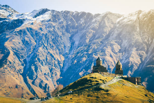 istock Stepantsminda, Georgia. Famous Popular Gergeti Trinity Tsminda Sameba Church In Early Winter Landscape. Beautiful Georgian Mountains Landscape 1440578526