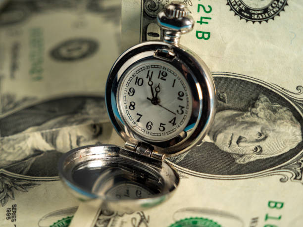 istock Old pocket watches lie on dollar bills. 1440579768