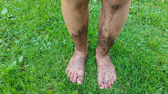 A man in sneakers runs on the ground. Sneakers in the mud. Modern sneakers.