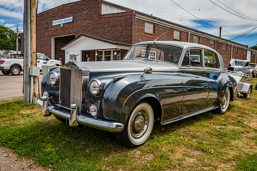 Des Moines, IA - July 02, 2022: High perspective front corner view of a 1960 Rolls Royce Silver Cloud II Sedan at a local car show.