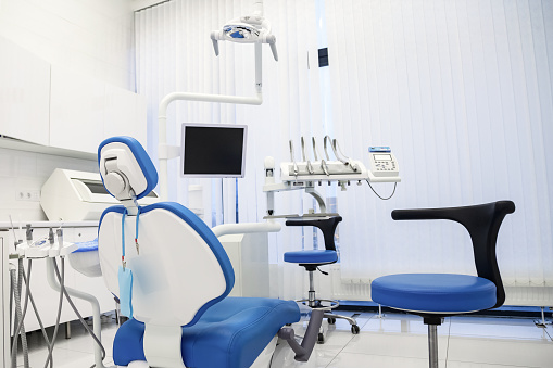 Professional stomatological equipment for dentist in medical office. Cozy dental room interior in modern stomatological clinic. Background of chair, accessories used by dentists. Copy text space