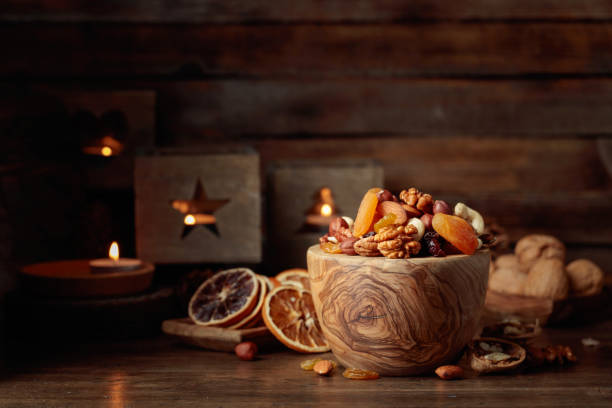 istock Dried fruits and assorted nuts on a wooden table. 1440583564