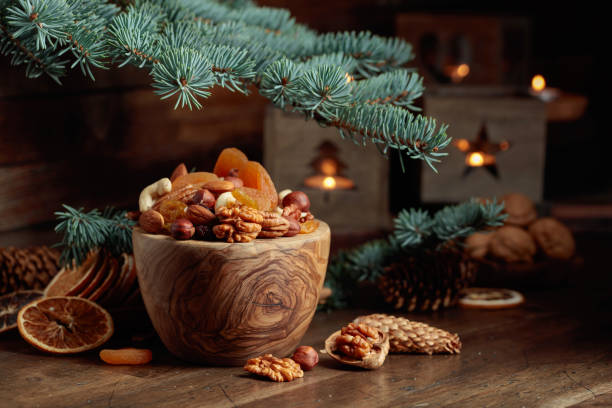 istock Dried fruits and assorted nuts on an old wooden table. 1440583568
